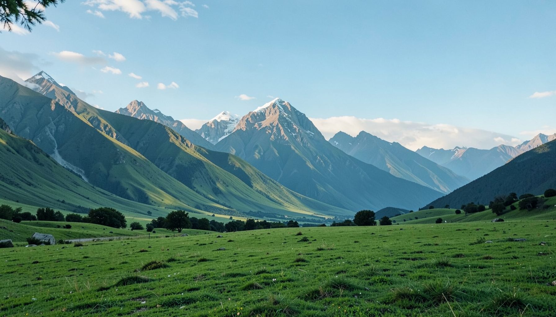 Wide green landscape with tall Andean mountains under a soft blue sky, evoking an open cinematic outdoor setting